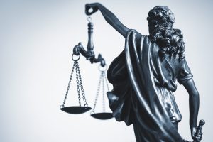 Cropped view of a statue of Justice with the scales of law and order wearing a blindfold signifying impartiality of judgement